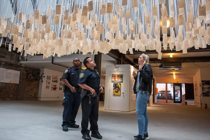 Two NYPD officers visited the Museum of Broken Windows on Sunday. Daveen Trentman of the Soze Agency, which helped the NYCLU curate the pop-up, gave them a tour.</br>